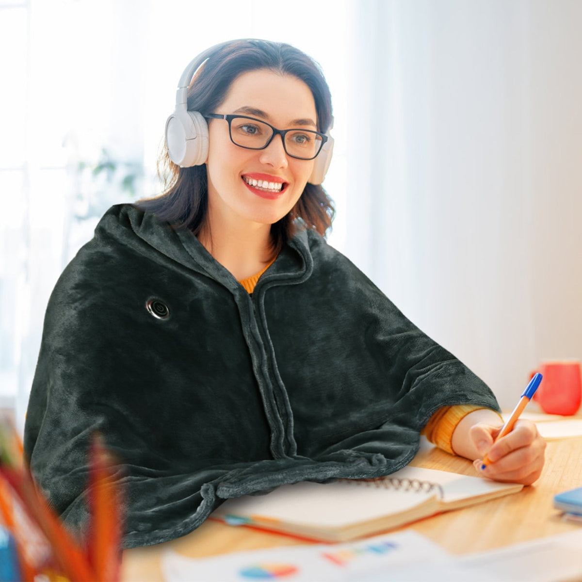 USB heated wearable blanket wrap worn as a cozy wrap while working at desk with hands free