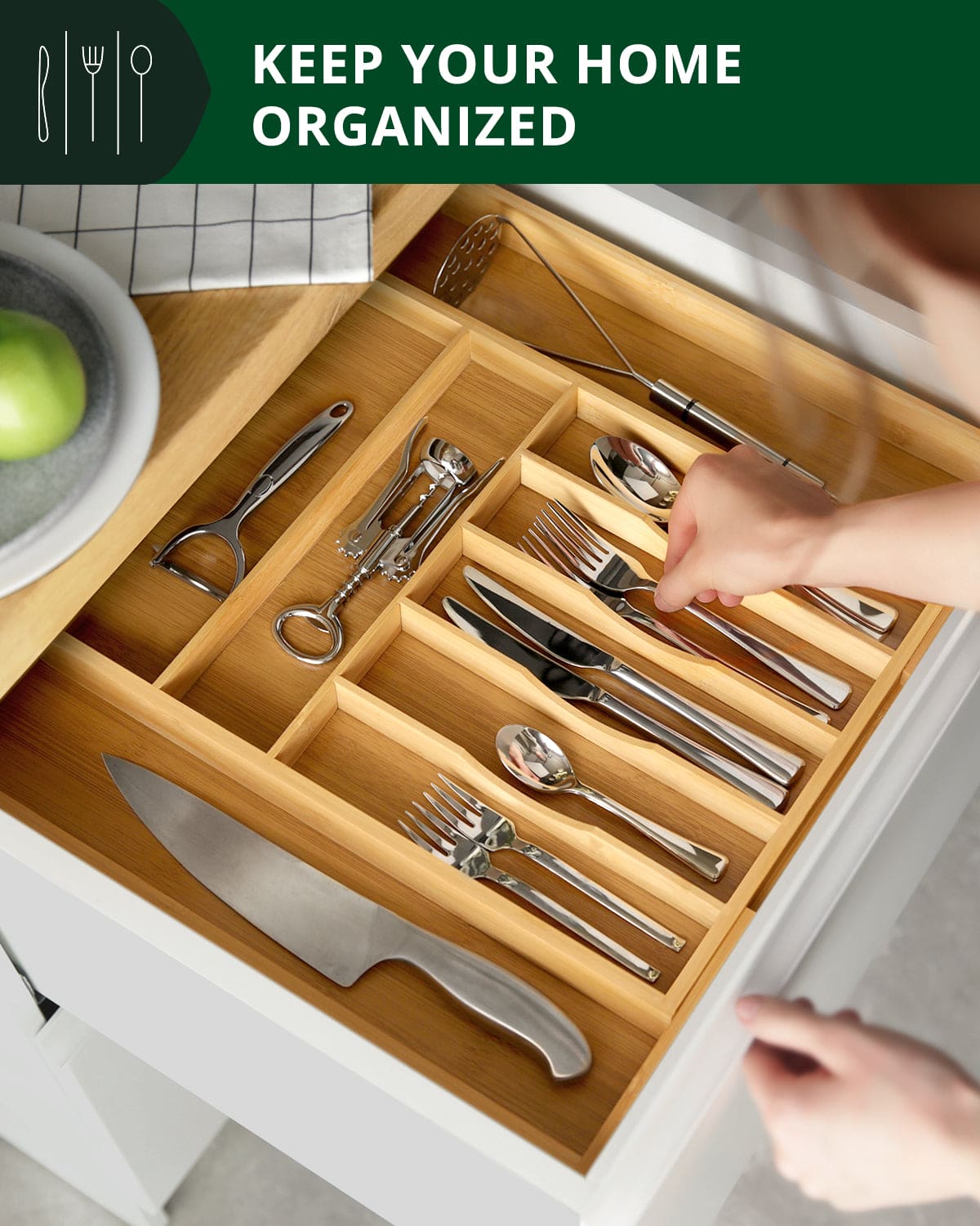 Expandable bamboo drawer organizer with 9 slots holding organized utensils and kitchen gadgets