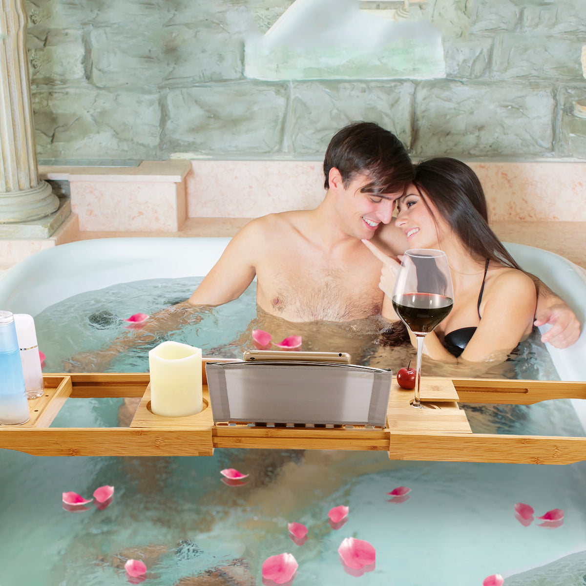bamboo bathtub caddy with book holder holding wine glass and candle during relaxing bath