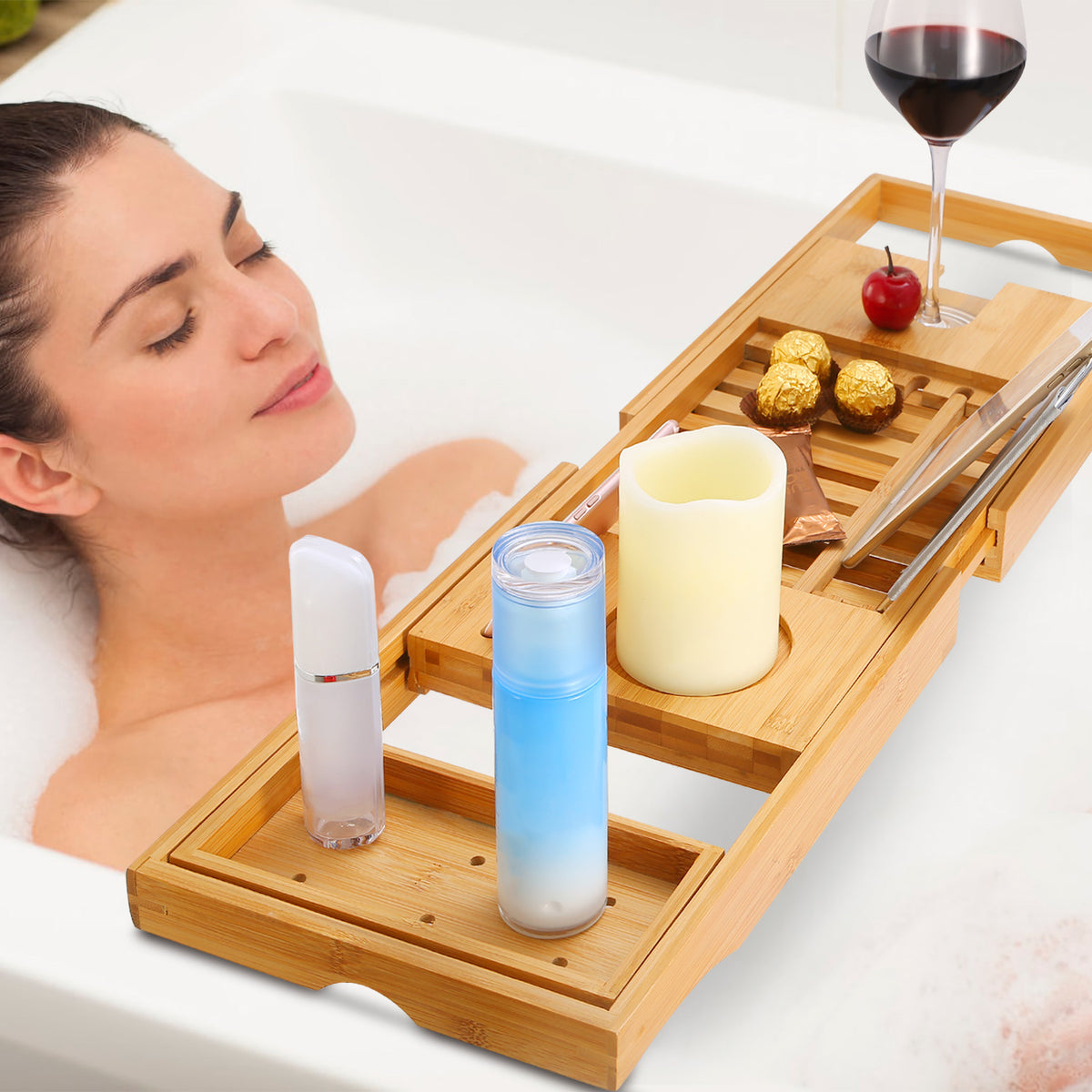 bamboo bathtub caddy with book holder displaying drinks, candle, and accessories during relaxing bath