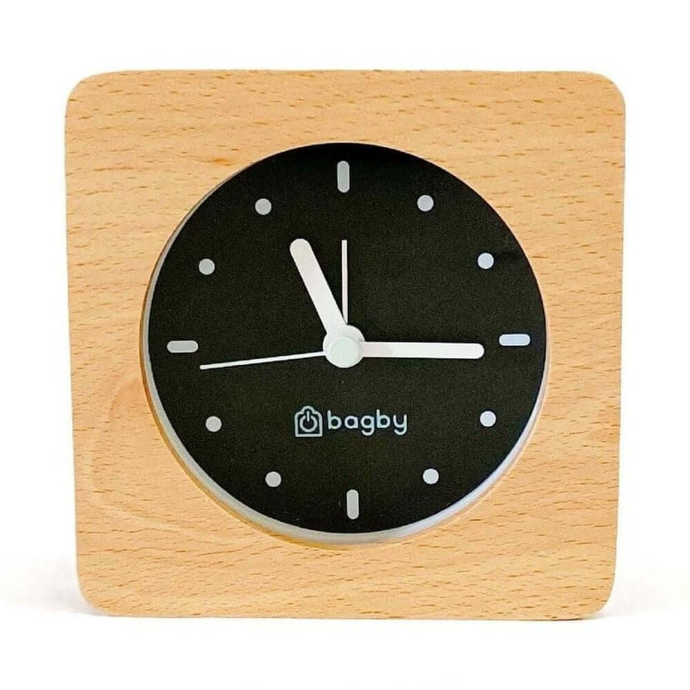 Silent wooden alarm clock with night light features minimalist design and non-ticking movement for a peaceful bedroom.