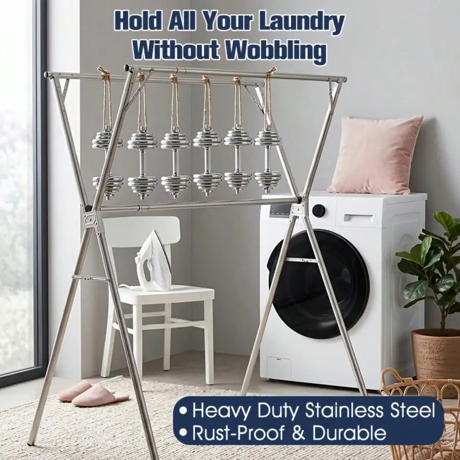Foldable stainless steel drying rack with multiple hanging bars holding laundry in modern laundry room next to washing machine