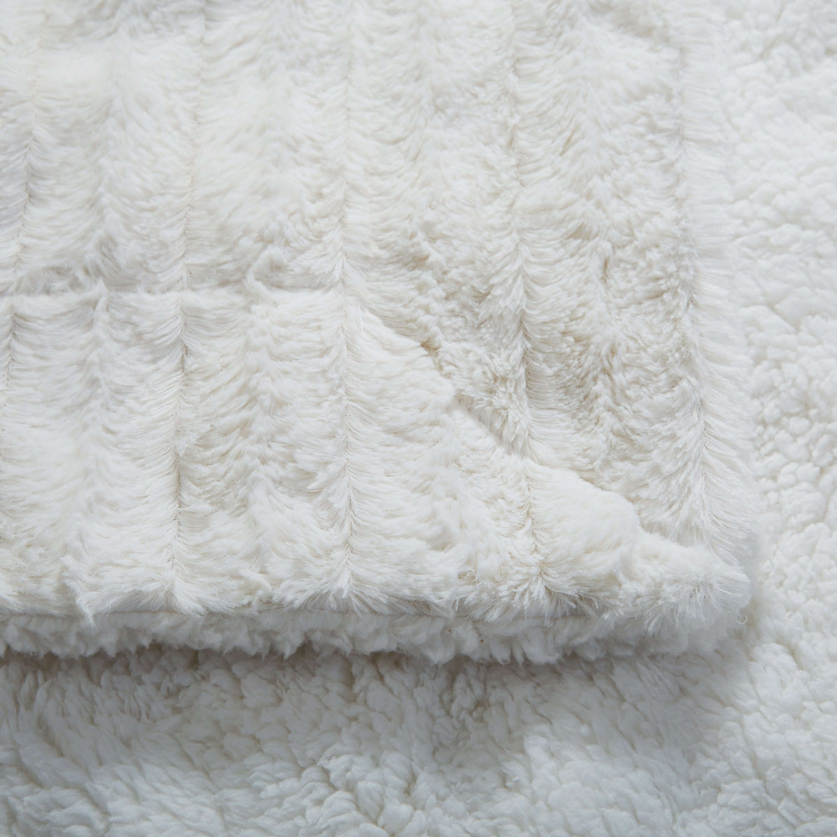 Faux fur sherpa throw blanket in white ivory showing plush faux fur texture and soft sherpa backing for cozy warmth