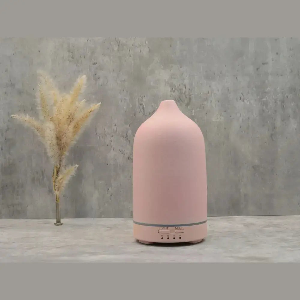 Ceramic essential oil diffuser shown in pink as a home decor accent