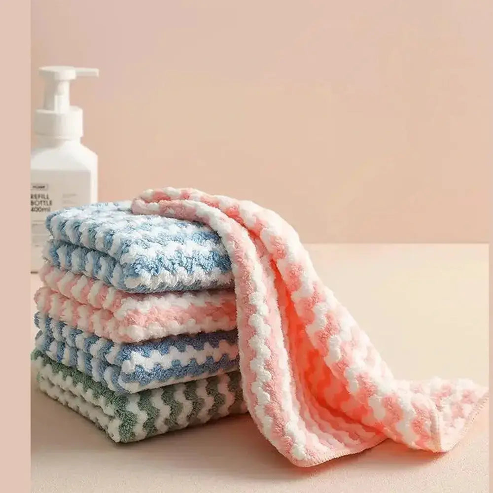Eco-friendly microfiber dishcloths stacked with one draped, ideal for sustainable kitchen cleaning.