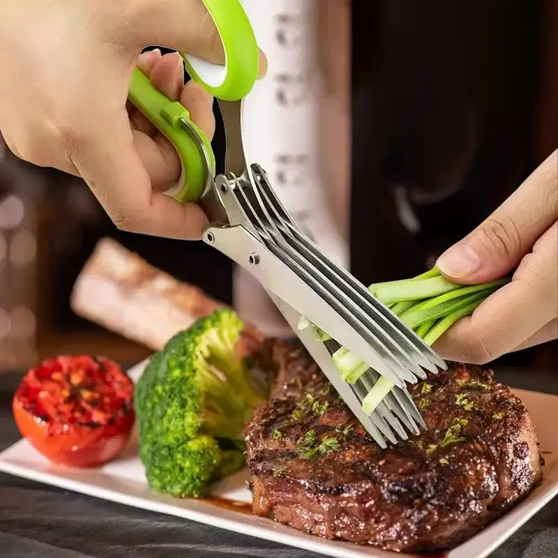 Five Blade Stainless Steel Herb Scissors cutting green onions next to a steak dinner.