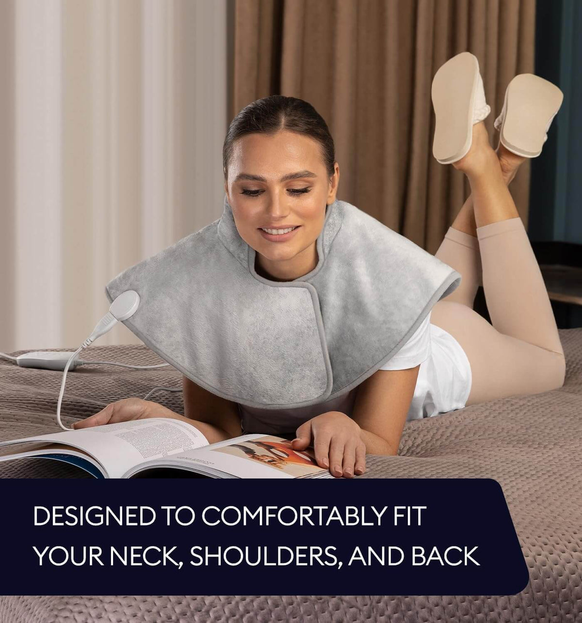 Geniani neck and shoulder heating wrap in Mist Gray draped on woman reading, showing comfortable fit