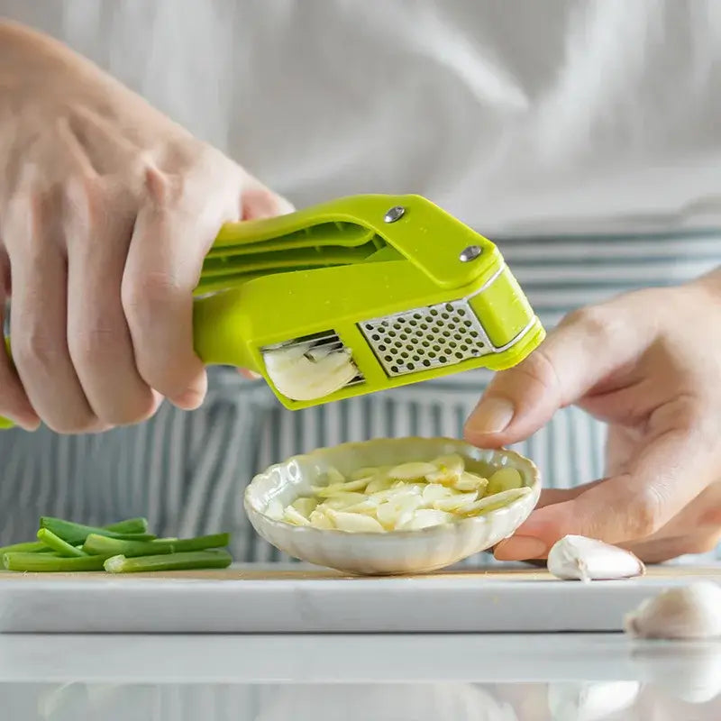 2-in-1 Garlic Press and Slicer, Green Options in use, showcasing garlic slicing with fresh ingredients.