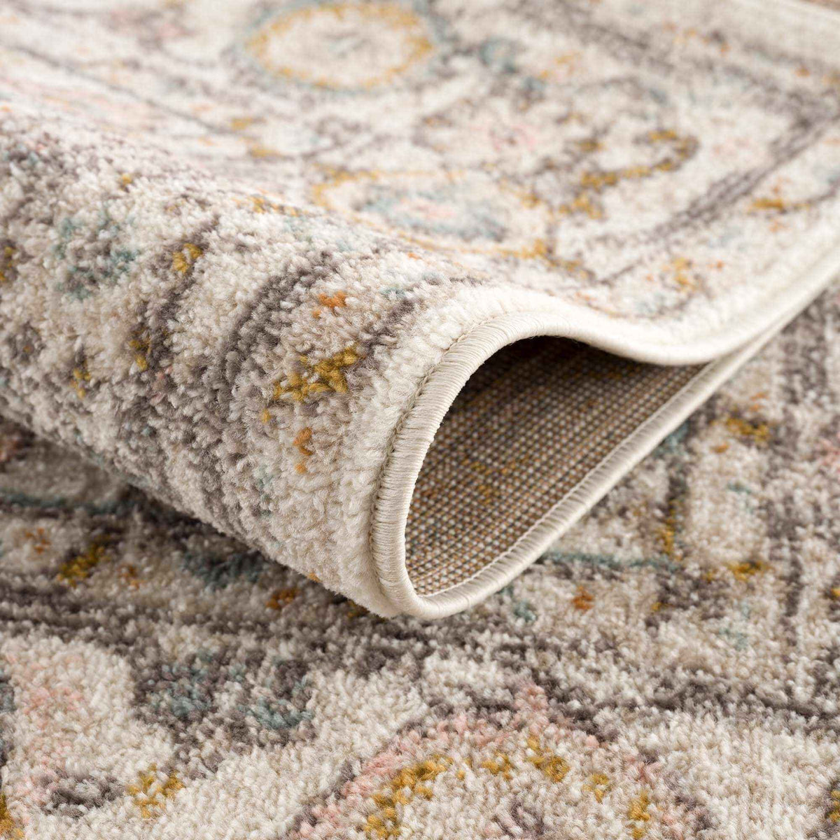 Close-up of the Herstmonceux area rug's floral pattern and color palette.