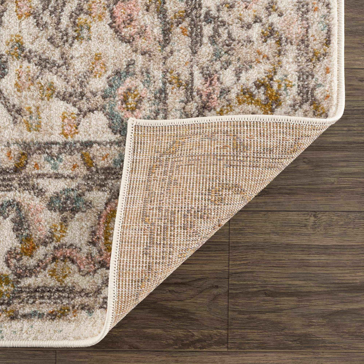 Herstmonceux elegant area rug placed under a dining table set.
