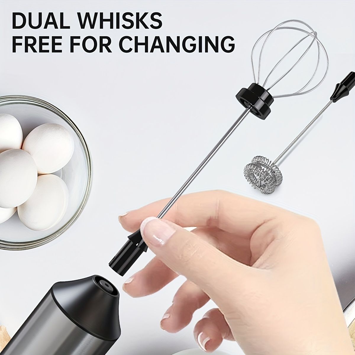 Rechargeable handheld milk frother with 2 interchangeable whisk heads for frothing and mixing, displayed with milk and black handle