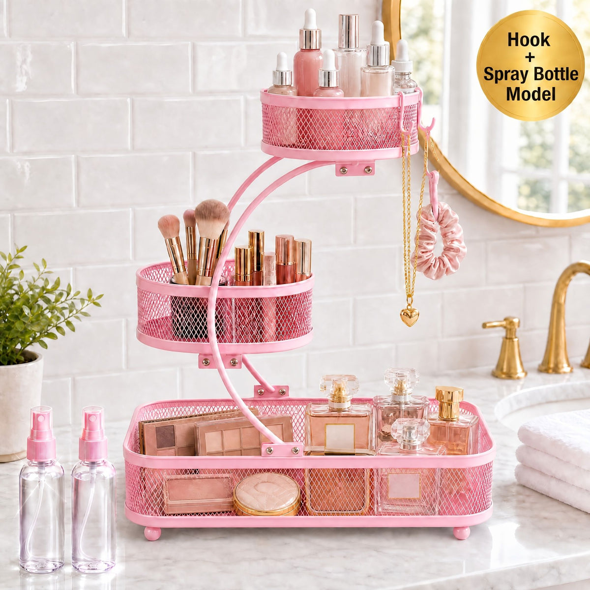 Pink 3-tier metal bathroom organizer with hooks holding makeup, skincare, and spray bottles on bathroom counter