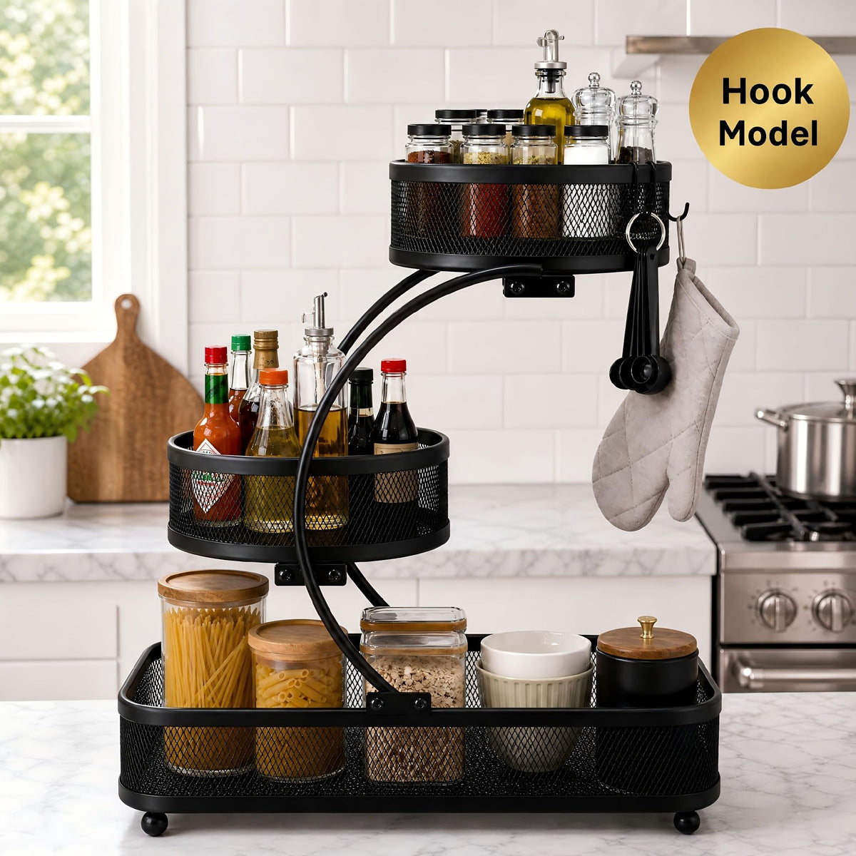 Black 3-tier metal bathroom organizer with hooks holds bottles, jars, and toiletries on white subway tile kitchen counter