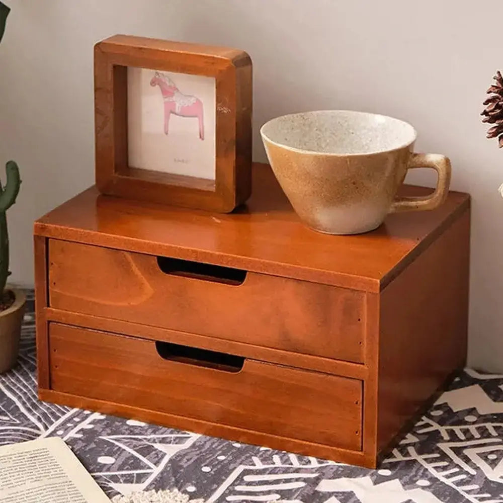 Wooden desk organizer with drawers featuring two drawers, a frame, and a cup, perfect for a minimalist workspace.