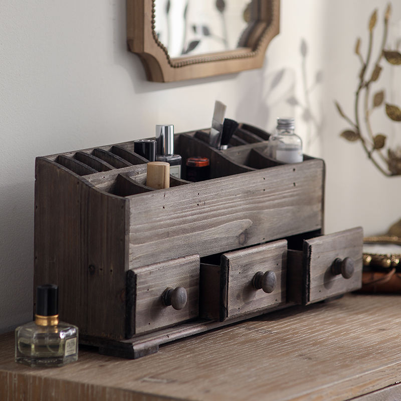 rustic wooden desk organizer with drawers holding makeup, pens, and accessories on vanity