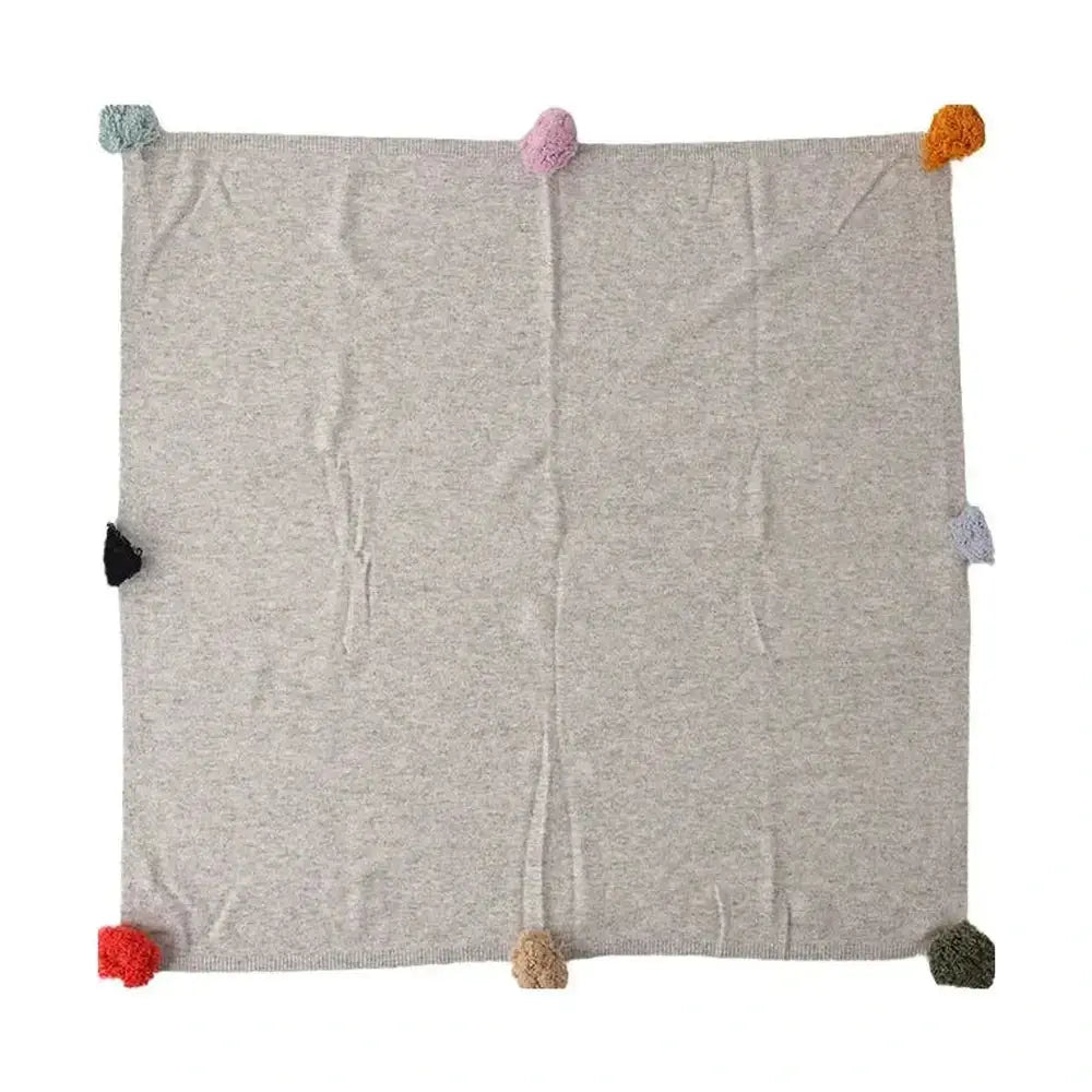 Luxury cashmere throw blanket folded to show its chunky knit texture