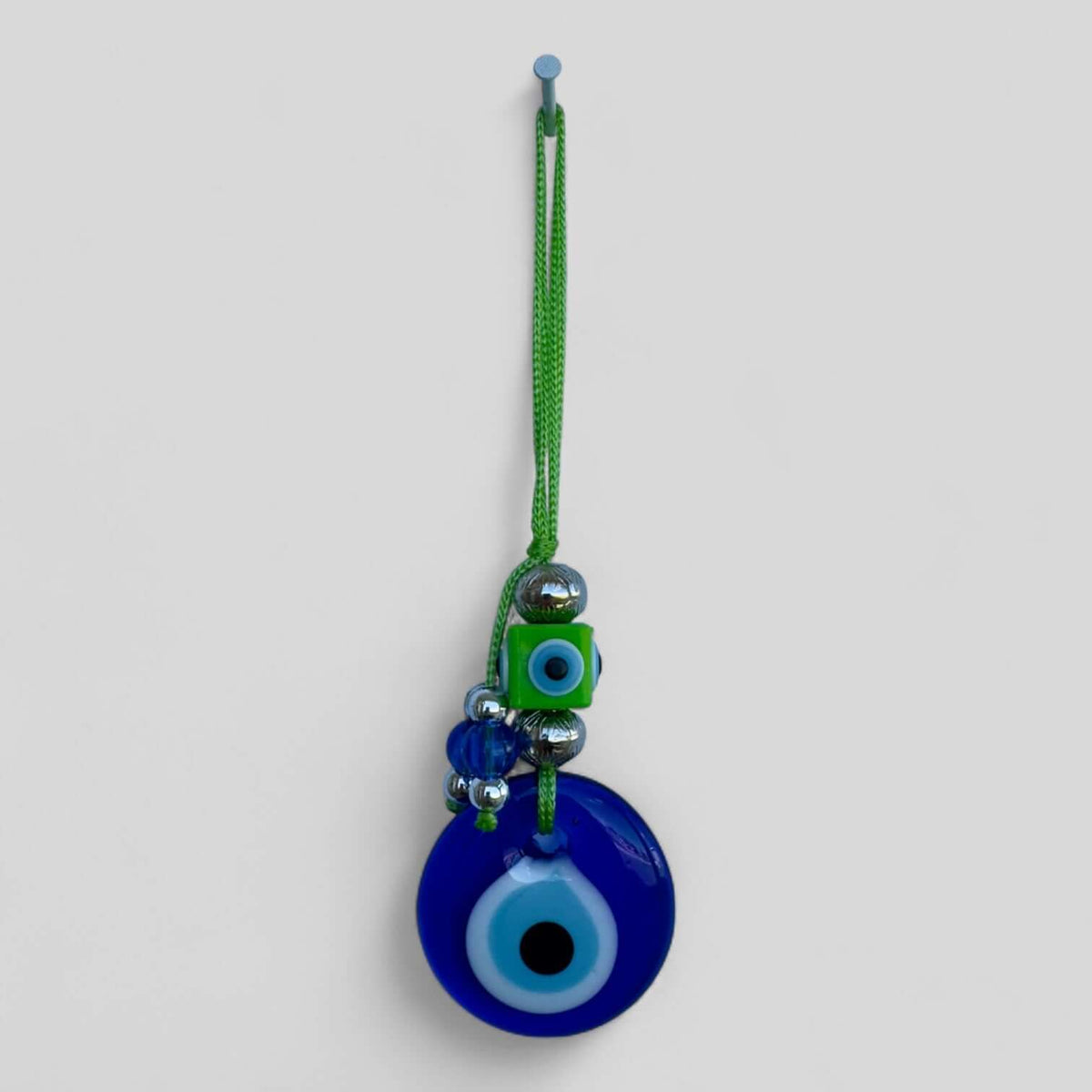 Modern boho evil eye wall hanging packaged and ready for gifting.
