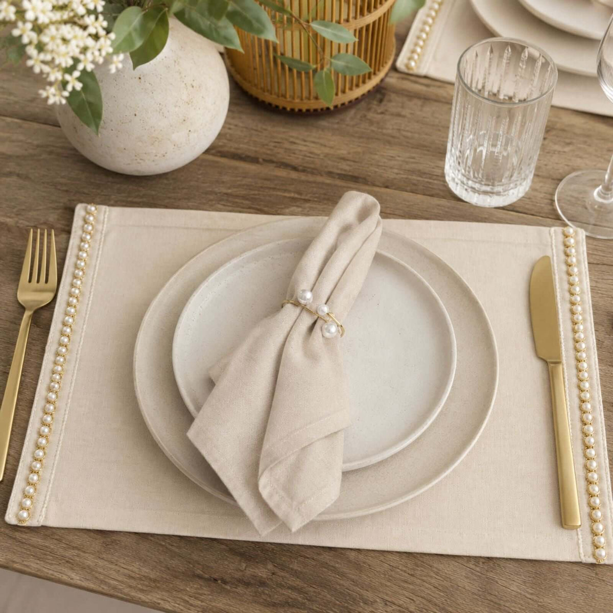 Set of four hand-embroidered organic cotton placemats with a pearl detail.