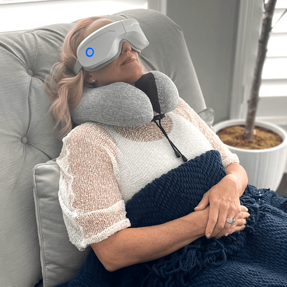 Woman relaxing with Relaxable™ heated eye massager providing gentle warmth and vibration for eye relief