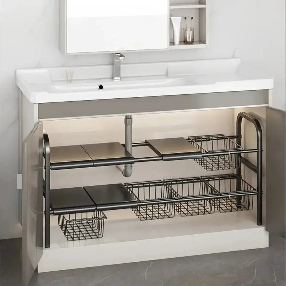 Expandable under-sink shelf organizer features adjustable storage with visible items for easy access in bathroom or kitchen cabinets.