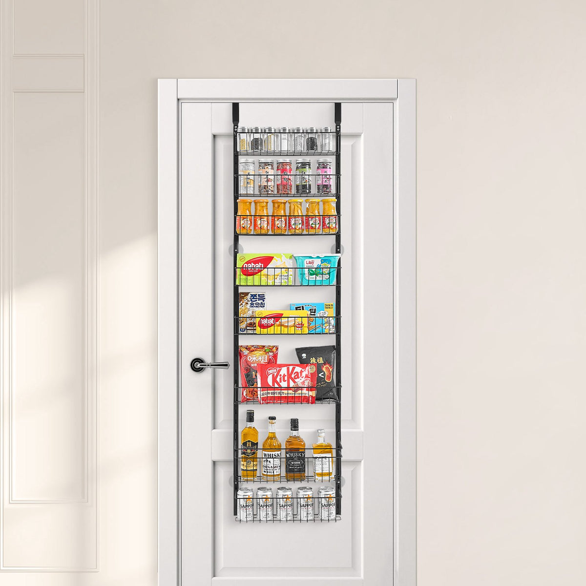 Black 8-tier over-the-door pantry organizer with adjustable baskets mounted on white door holding spices, cans, and snacks
