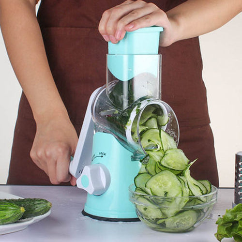 Mandoline vegetable slicer in turquoise creating thin, even cucumber slices for meal prep