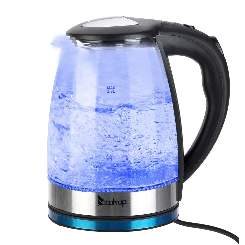 Glass electric kettle glowing blue on its base