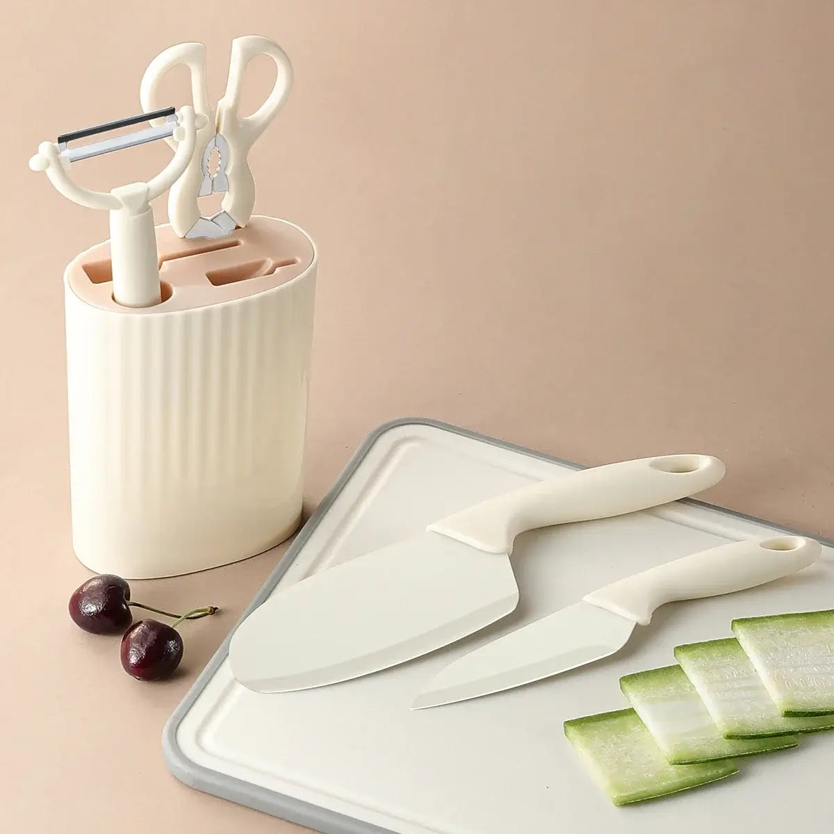 5-piece kitchen knife set with scissors includes knives, peeler, and scissors in a stylish storage block on a countertop.