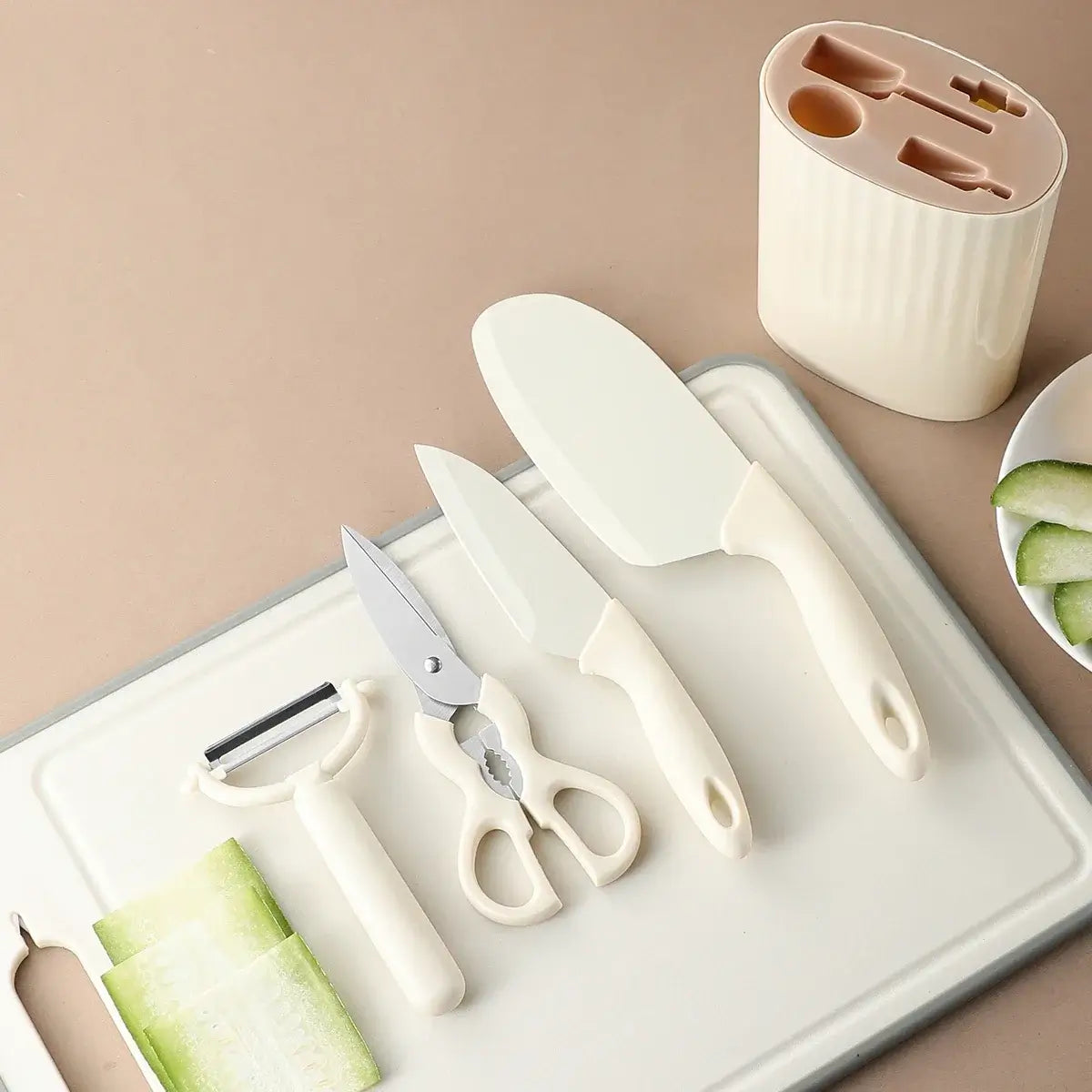 5-piece kitchen knife set with scissors on a cutting board, featuring knives, peeler, and kitchen scissors for versatile food prep.