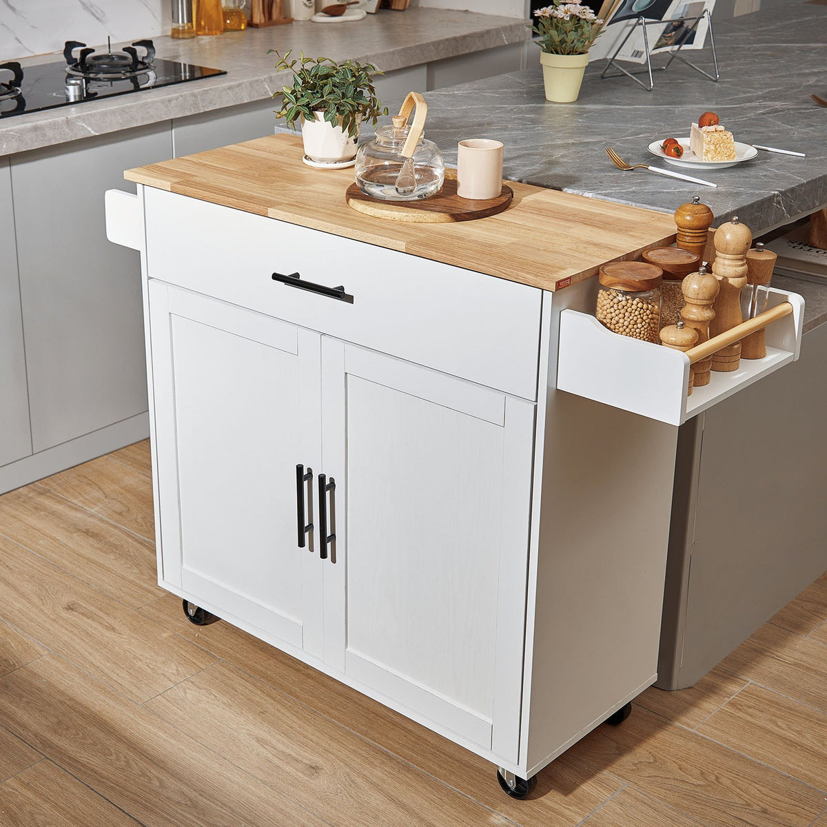White rolling kitchen island with drop leaf and rubber wood top displayed in modern kitchen with storage