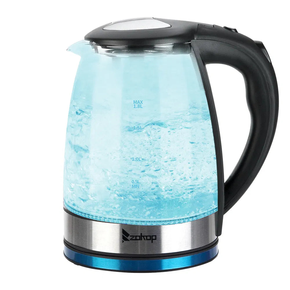 Glass electric kettle glowing light blue while heating