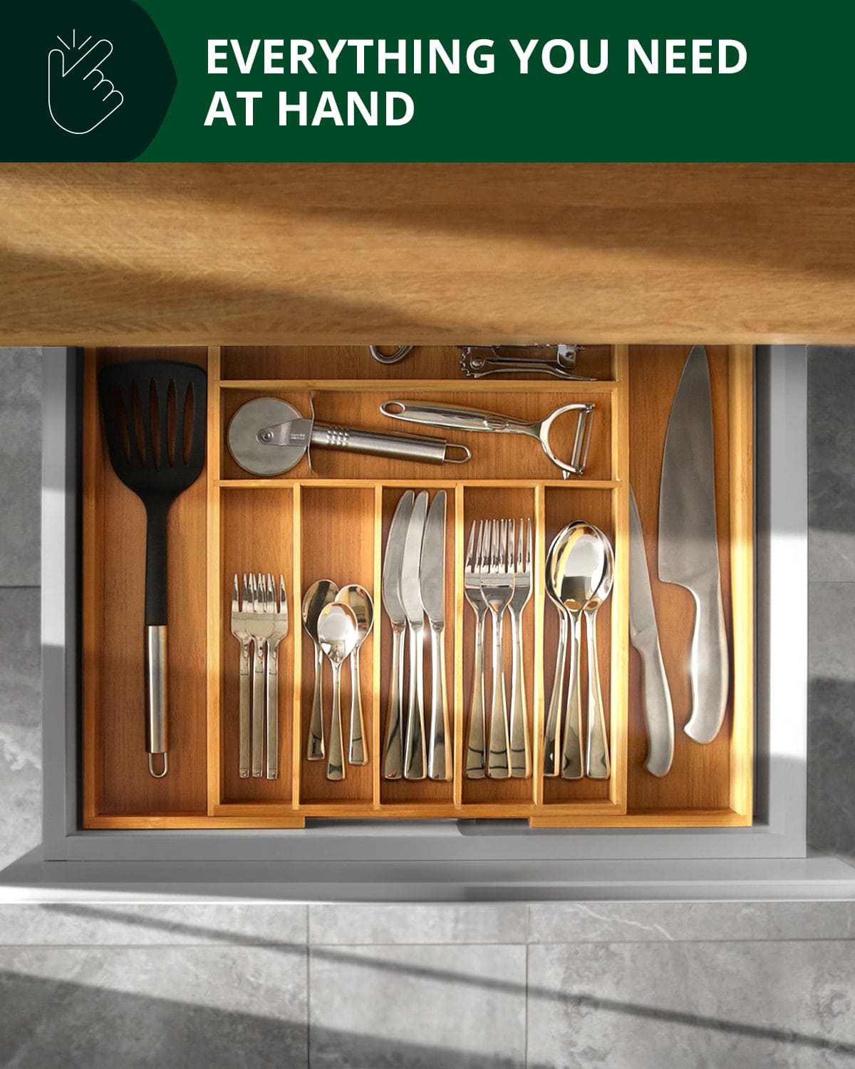 Expandable bamboo drawer organizer with 9 slots holding utensils, forks, knives, spoons and kitchen gadgets neatly organized