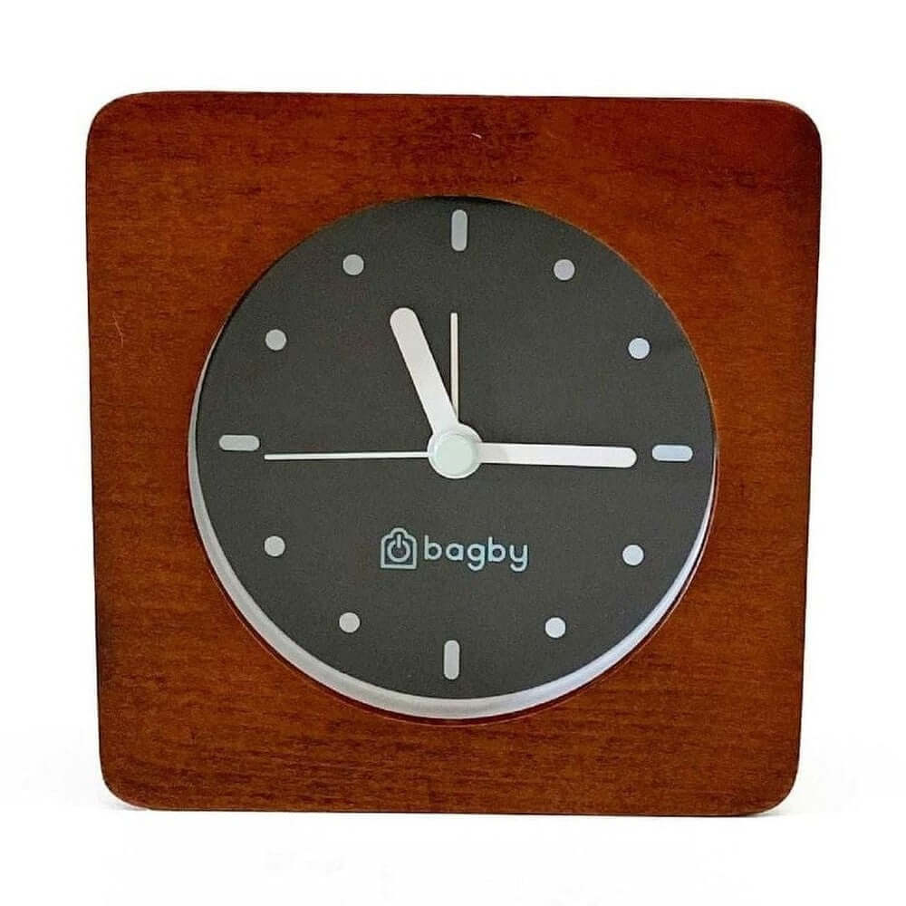 Silent wooden alarm clock with night light in dark wood, offering a minimalist design for a peaceful bedroom.