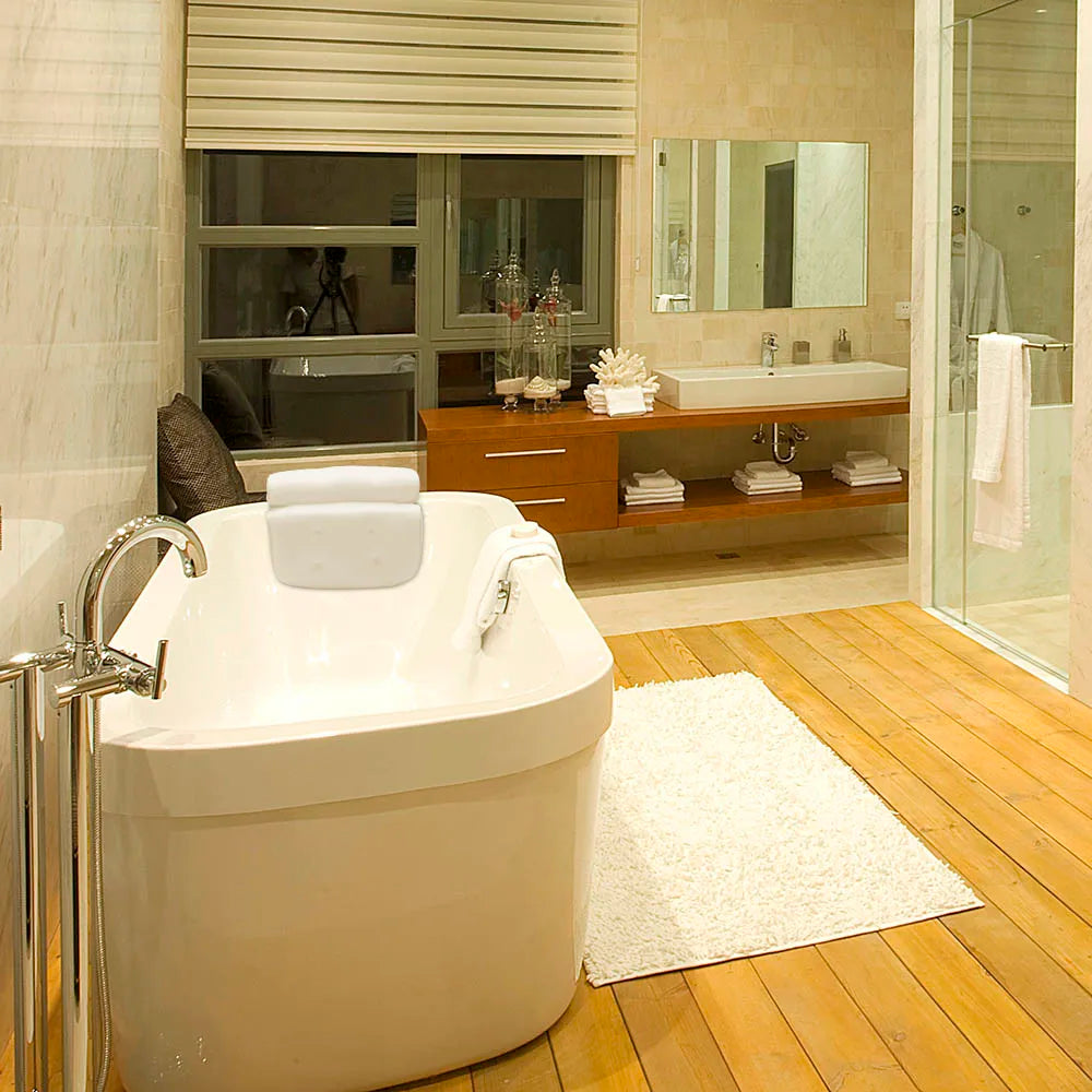 spa bath pillow with back support positioned on white bathtub edge in modern bathroom