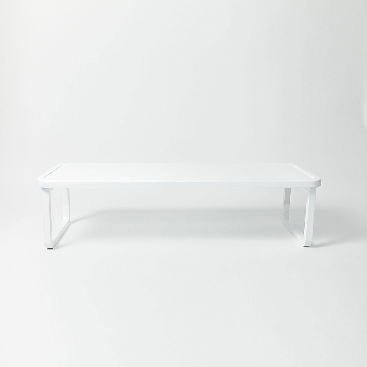 Stackable white wooden shoe shelf holding shoes