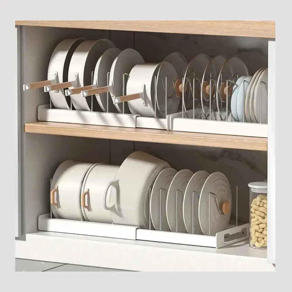 Adjustable pot and pan organizer in a kitchen cabinet keeping cookware upright and separated.