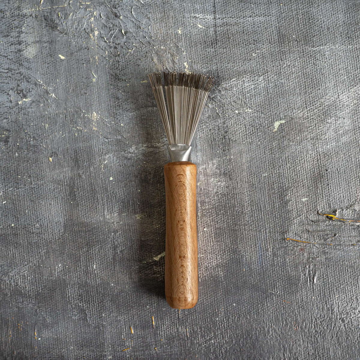 Close-up of the bamboo hair brush's natural bristles and wooden handle.