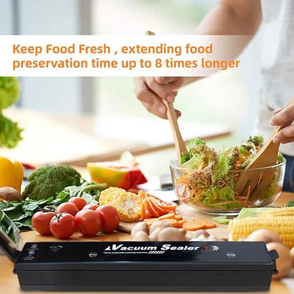automatic vacuum sealer machine keeping food fresh with vegetables and sealed bags on kitchen counter