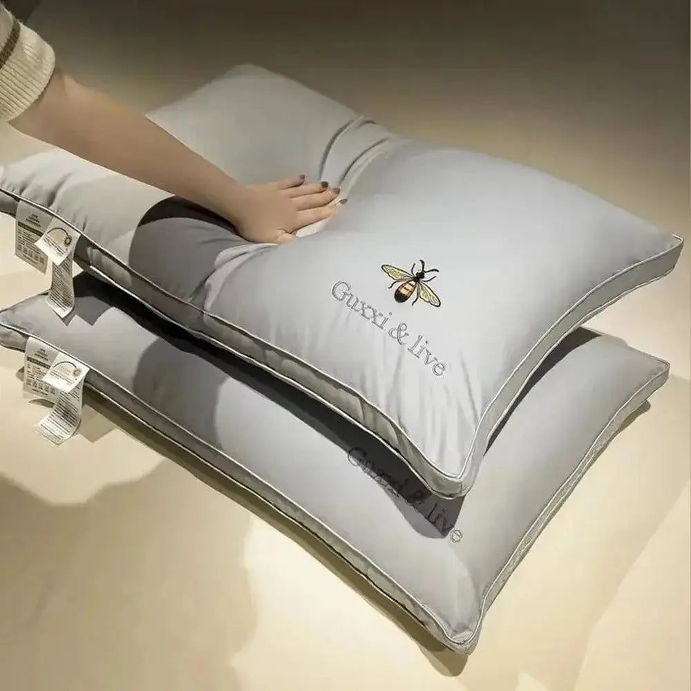 Cervical massage pillow in light grey, shown from the side to highlight the contoured support ridge.