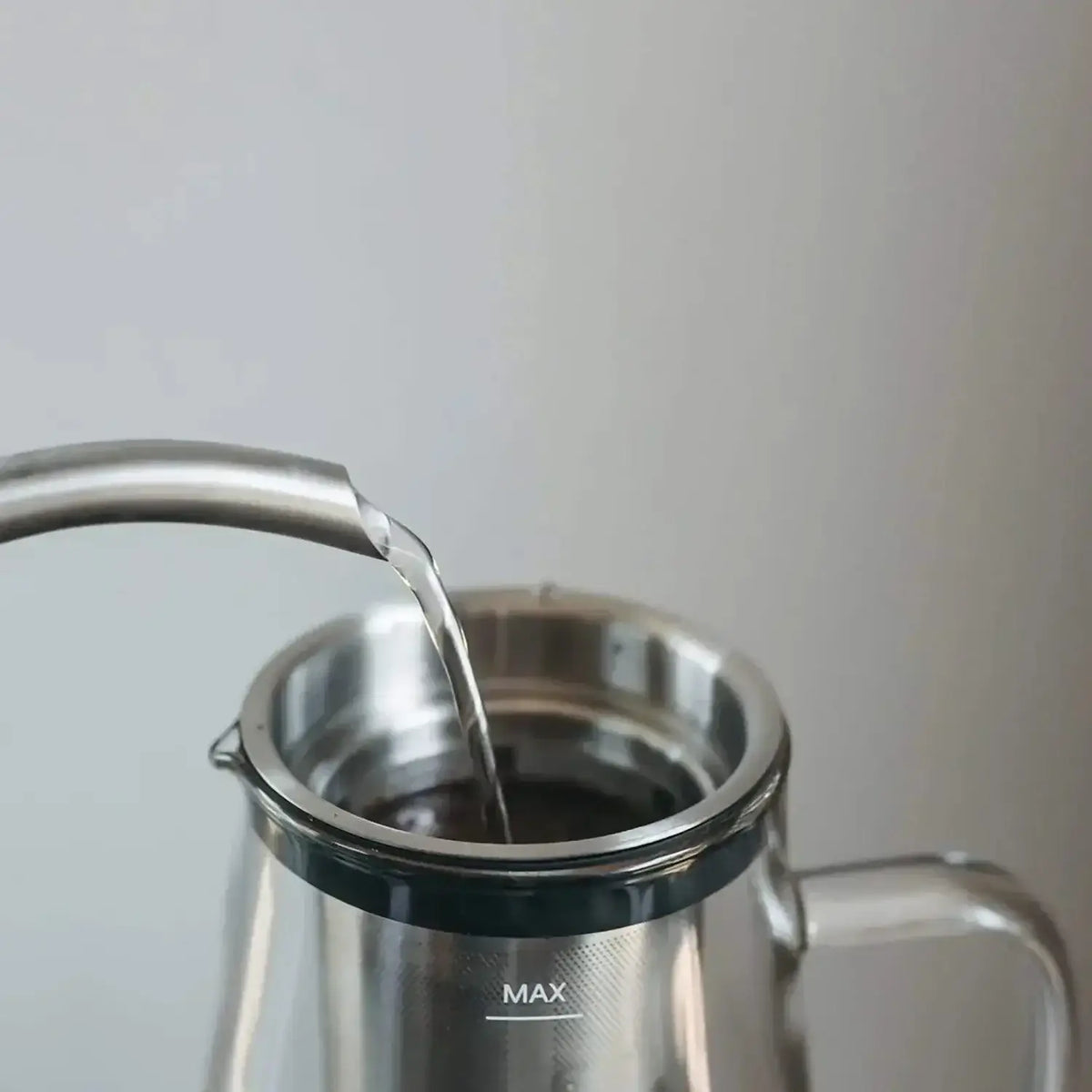 Pouring water into the easy cold brew coffee maker for a perfect cold brew coffee.