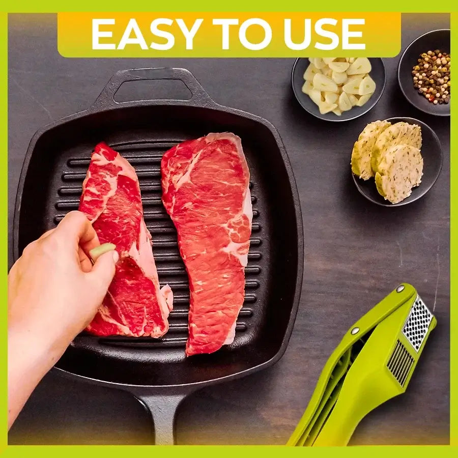 2-in-1 Garlic Press and Slicer, Green Options being used with meat on a grill pan.