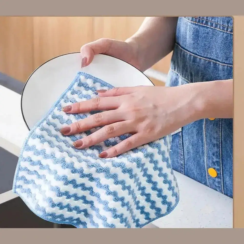 Eco-friendly microfiber dishcloth used to clean a plate in the kitchen, showcasing its practicality and effectiveness.