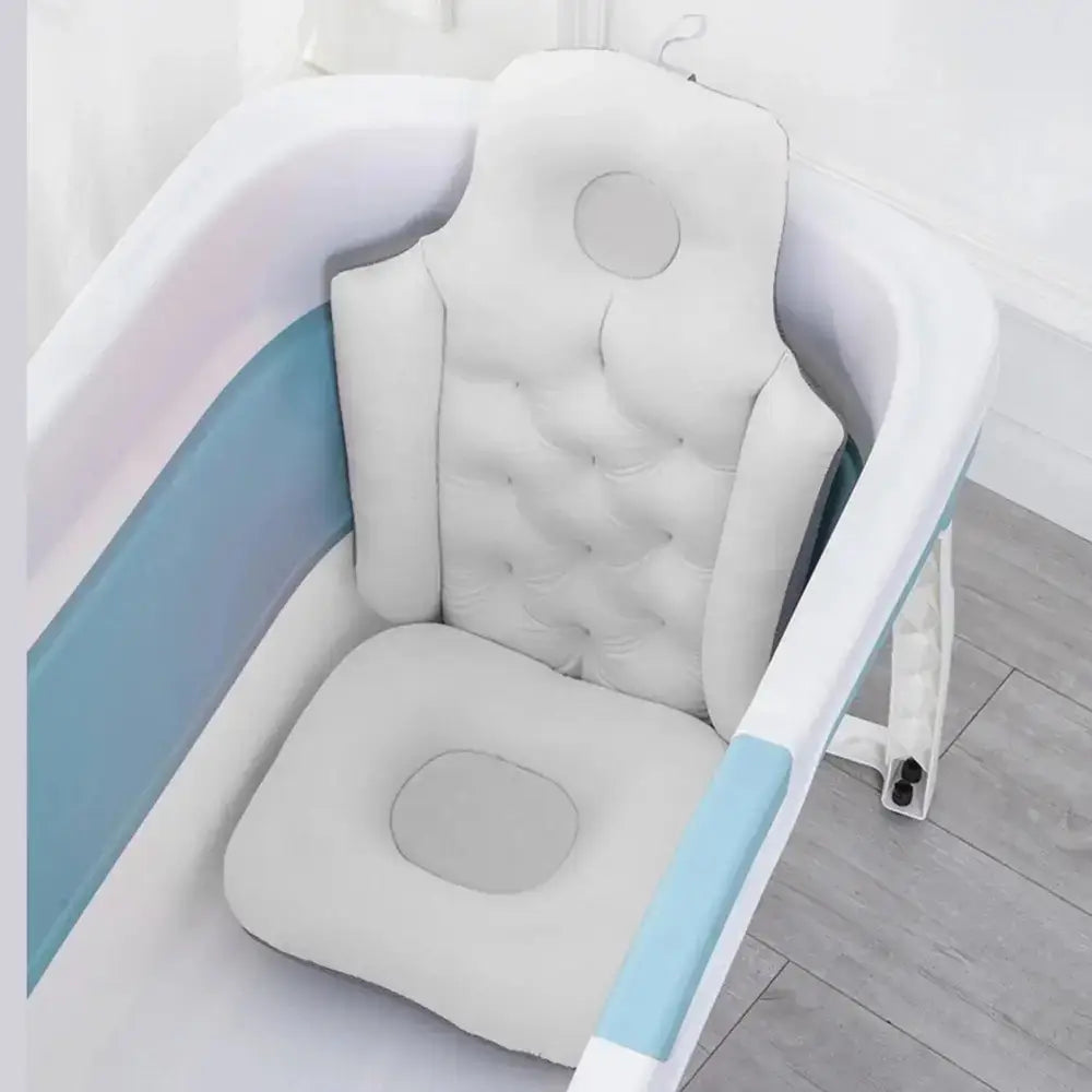 Ergonomic bath pillow and seat cushion positioned in a bathtub for spa-like support.