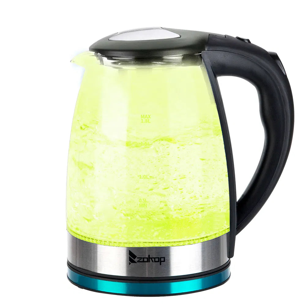 Glass electric kettle glowing yellow while heating