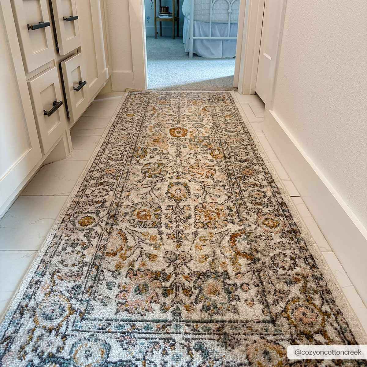 Herstmonceux elegant area rug shown rolled, highlighting its plush pile texture.