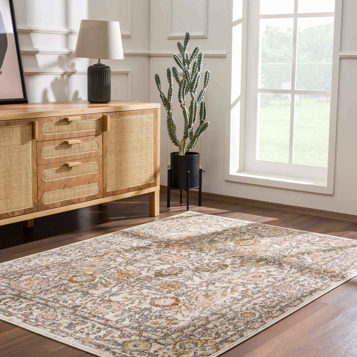 Elegant area rug placed in a stylish living room with a plant and decorative lamp.