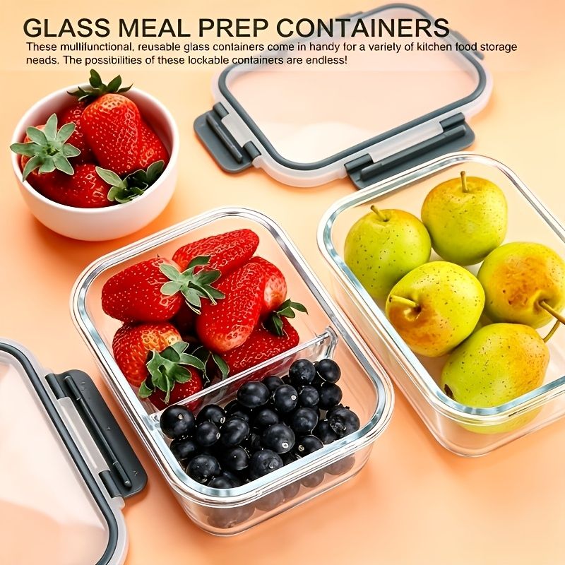 Glass food storage containers with lids filled with fresh strawberries, blueberries, and apples on peach background