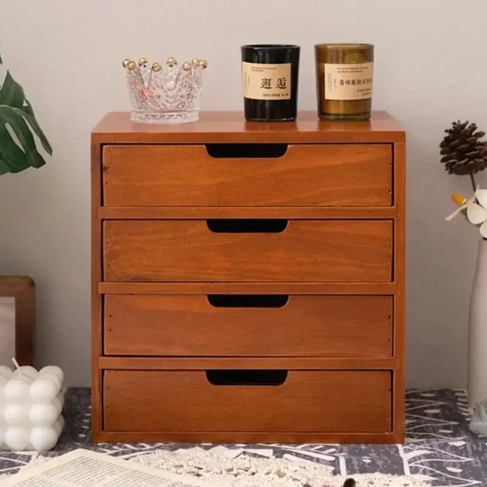 Wooden desk organizer with drawers showcasing four compartments on a stylish desk.