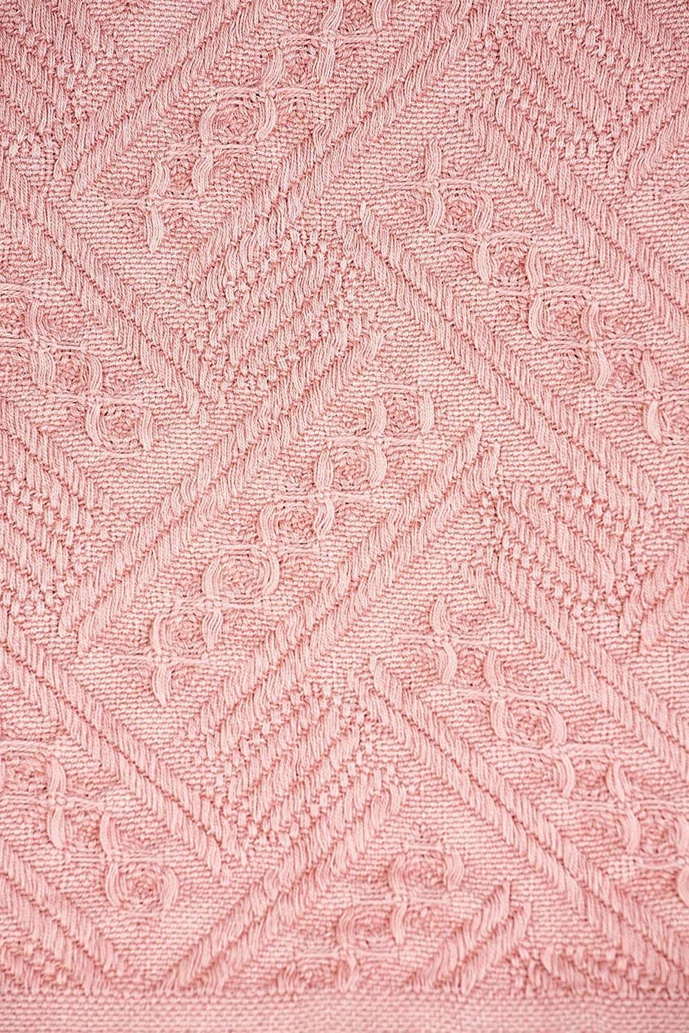 Kasentex cotton knit throw blanket in pink showing textured knit pattern and soft fabric detail