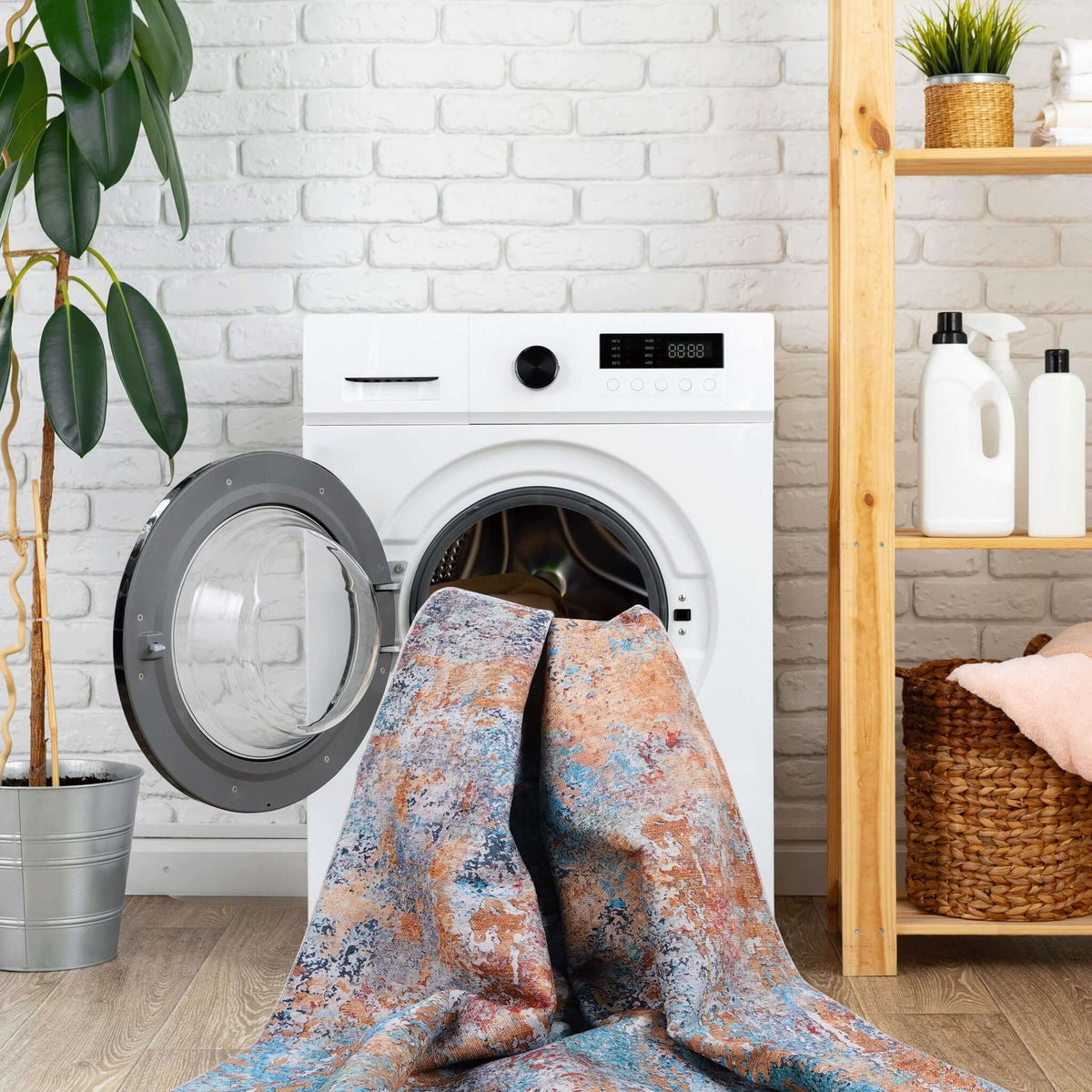 Luna Select Market washable area rug with a modern abstract pattern being placed into a white washing machine